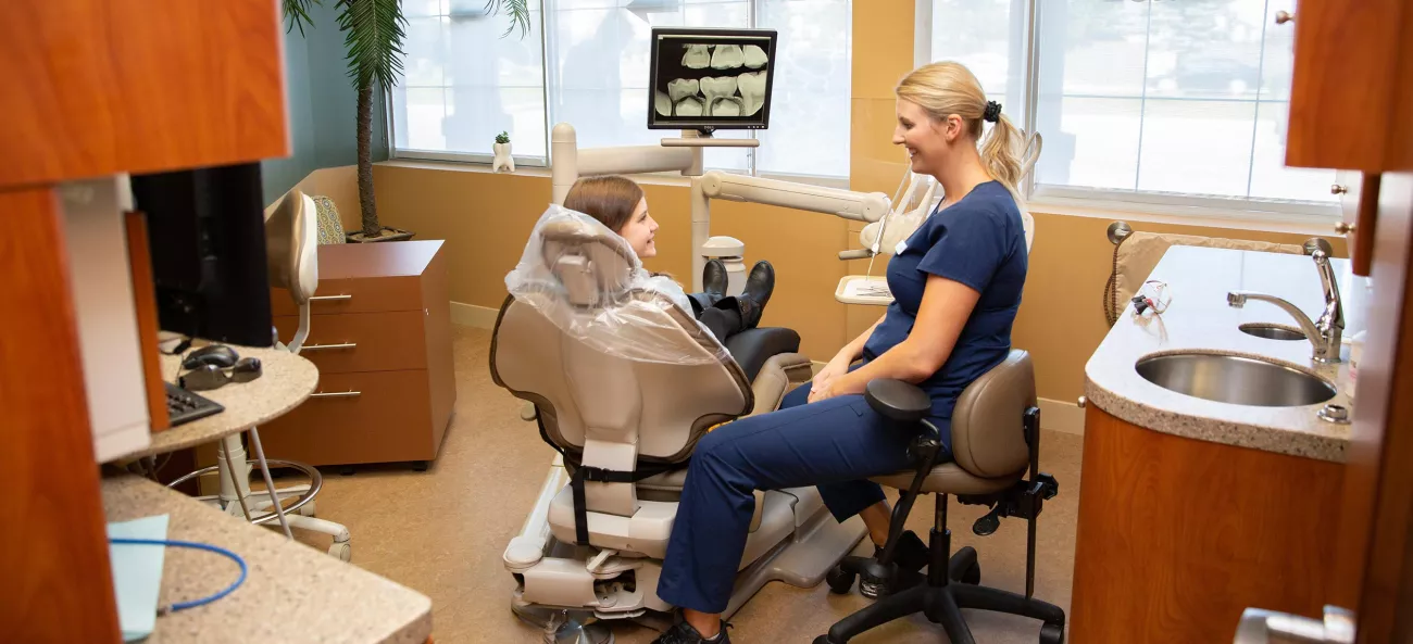 Consulting with dental patient