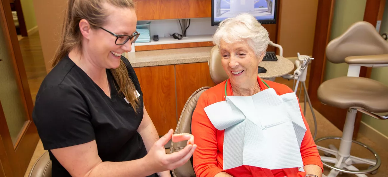 Showing dental model to patient